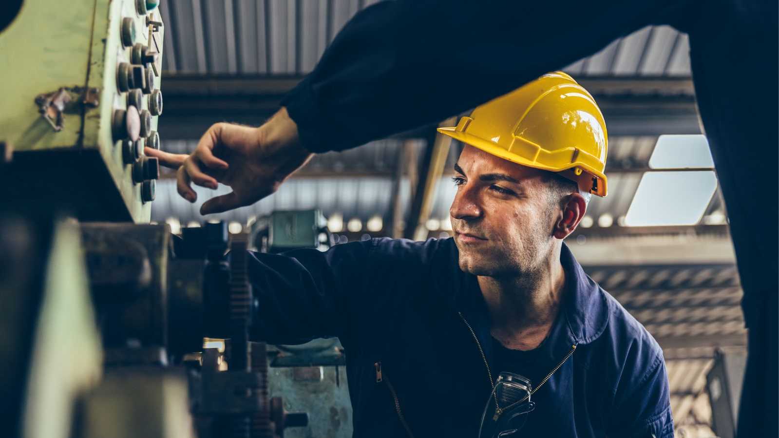 man fixing construction equipment