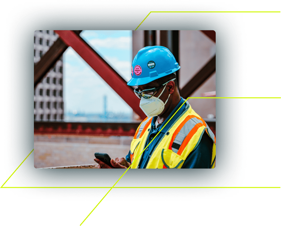 construction worker on cell phone at job site with mask