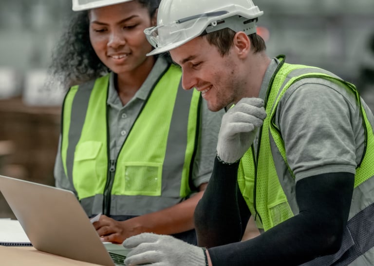 construction workers looking at laptop
