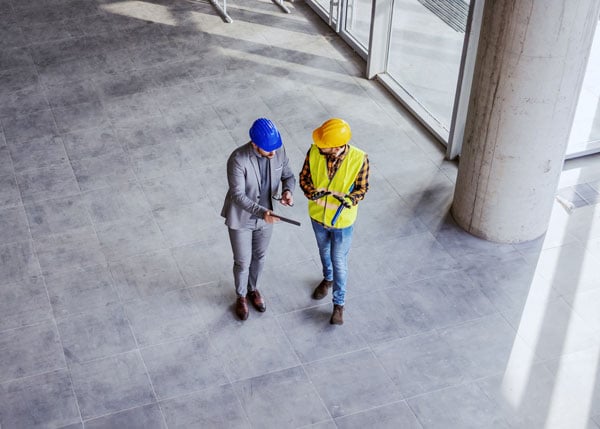 contractor and engineer having a conversation at a construction site