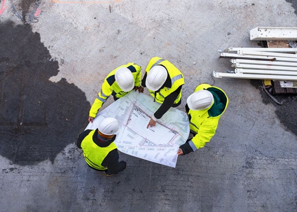 group of contractors looking at blueprint